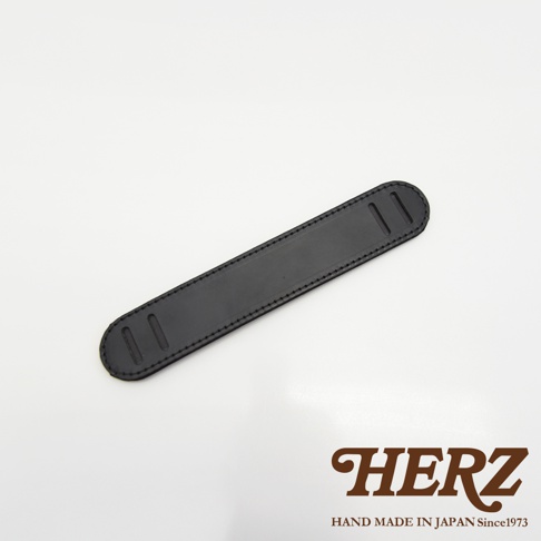 黑色皮革製成，帶有縫線裝飾的長方形肩墊，兩端有兩個切口。