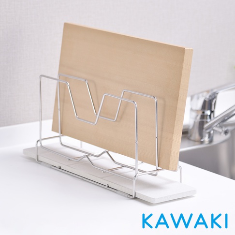 銀色金屬製成的鍋蓋砧板架，架上放置著一片淺棕色的木質砧板。架子下方有一塊白色珪藻土瀝水盤。