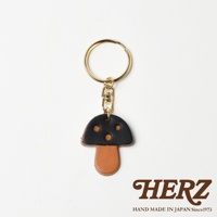 職人手作皮革香菇造型鑰匙圈，菌傘為黑色皮革，菌柄為棕色皮革，搭配金色鑰匙圈和鉤扣。