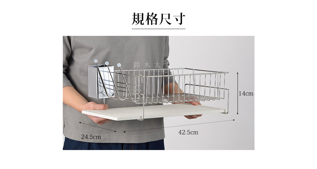 一位穿著灰色上衣的人正雙手拿著一個長方形的金屬瀝水架，架子下方附有一塊白色的珪藻土吸水墊，側邊設有金屬筷架。圖片標示規格尺寸長度為 42.5 公分、寬度 24.5 公分、高度 14 公分。