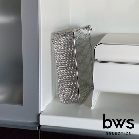 不鏽鋼方型瀝水籃，網狀結構，銀色金屬材質，置於白色檯面上，旁有一白色收納盒。