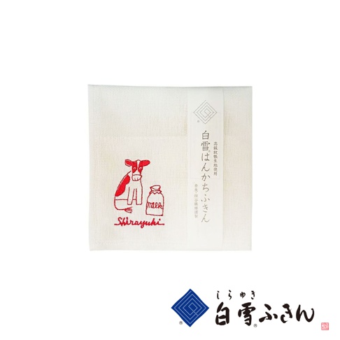 白色棉質方巾，繡有紅色卡通牛和一瓶牛奶圖案，下方有「Shirayuki」字樣。右側有日文標籤，材質為高級蚊帳生地。