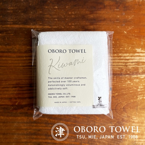 包裝內的白色細纖維毛巾，標籤上印有「OBORO TOWEL Kiwami」，並說明「The skills of master craftsmen, perfected over 100 years. Astonishingly voluminous and addictively soft.」毛巾材質為100%純棉，日本製造。