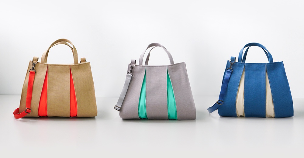 展示三個款式的京都職人手作ougi棉帆布兩用扇形托特包，分別為大地色配橘紅、灰色配淺綠、藍色配米白，皆有雙提把與可拆卸背帶。