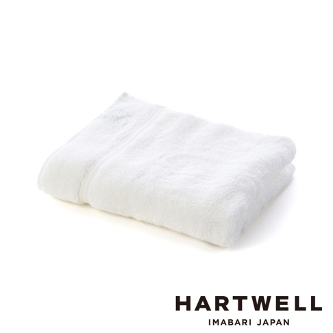 一張白色今治毛巾，質地柔軟，邊緣有細緻的織紋。