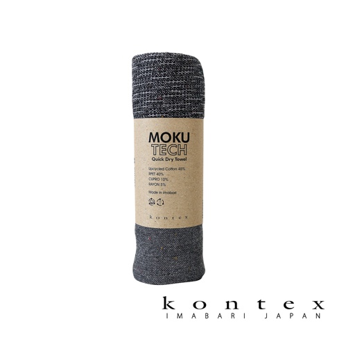 MOKU TECH超速乾長毛巾，採用深灰色混紡材質，表面有細緻紋理。包裝紙盒標示產品成分為再生棉45%、RPET 40%、CUPRO 10%、RAYON 5%，並註明「Made in Imabari」。