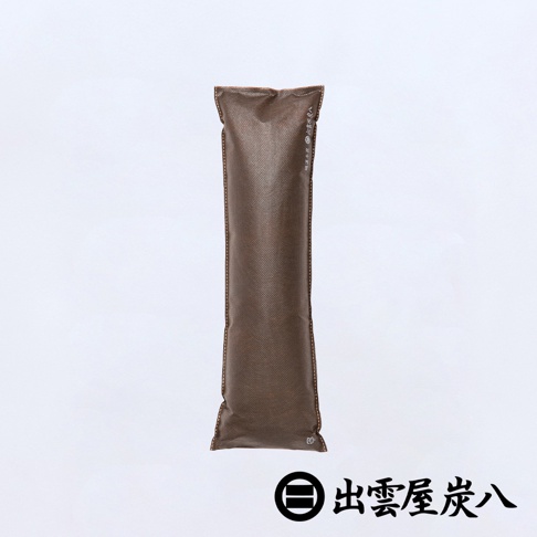 一個長條形的棕色不織布除濕調濕木炭包，表面具有細緻網狀紋理，邊緣以細線縫合，整體設計簡約。包裝側邊印有出雲屋炭八品牌字樣，圖片右下方亦標示出雲屋炭八的圓形品牌標誌與文字，此款窄版調濕木炭適合用於衣櫃或狹小空間，具備除溼與除臭功能。