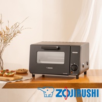 一台黑色小型電烤箱，配有玻璃門、銀色把手和黑色旋鈕控制面板。