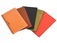 五款顏色各異的職人手作皮革存摺文件收納夾，包含淺棕色、深棕色、黑色、橄欖綠和紅色。皆為真皮材質，以白色車線縫製，設計簡約，可收納存摺或文件。