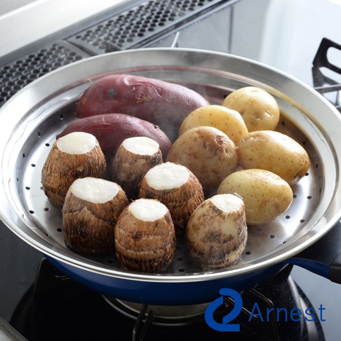 不鏽鋼蒸盤中盛有地瓜、馬鈴薯和芋頭，蒸氣瀰漫，蒸盤置於藍色鍋子上。