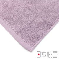 淺紫色毛巾，材質為柔軟的棉質，具有明顯的織紋和包邊細節。