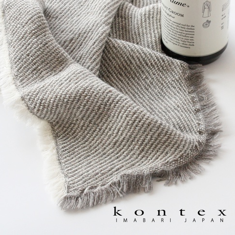 SWELL 質感流蘇鬆餅紋長毛巾，以灰白色交織的細膩織紋呈現，兩側帶有天然流蘇邊緣，材質觸感柔軟。