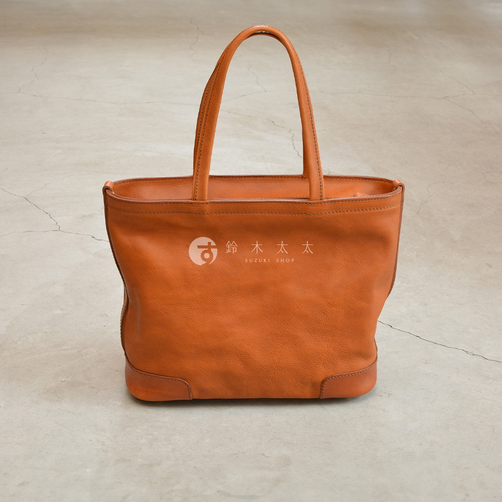 職人手作皮革Organ肩背拉鍊托特包，橘棕色，簡約托特包款式，有雙提把，包身有品牌Logo。