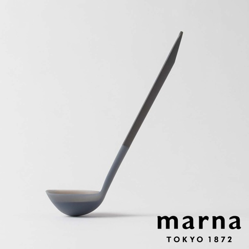 marna TOKYO 1872 品牌標誌旁有一個灰藍色的三角形耐熱矽膠料理湯杓，湯杓的長柄呈深灰色，湯杓部分為灰藍色和淺灰色，整體背景為淺灰色。