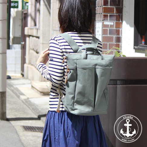 灰綠色高島帆布後背包，有兩個前置口袋和兩個側袋，採用簡約設計，適合日常攜帶。