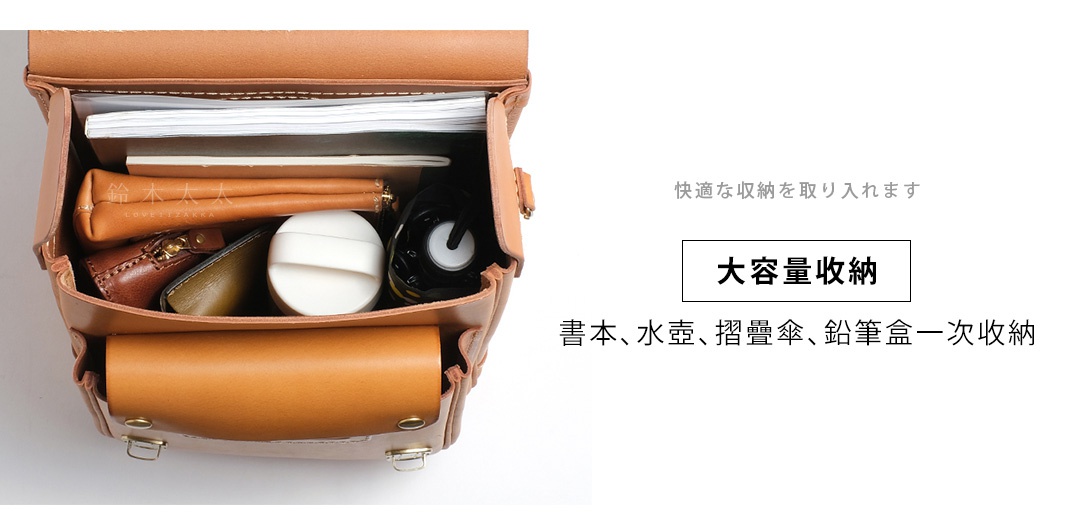 職人手作皮革小學生書包 R-51-AS，展示其寬敞的內部空間，內有書籍、皮夾、化妝包和水壺。