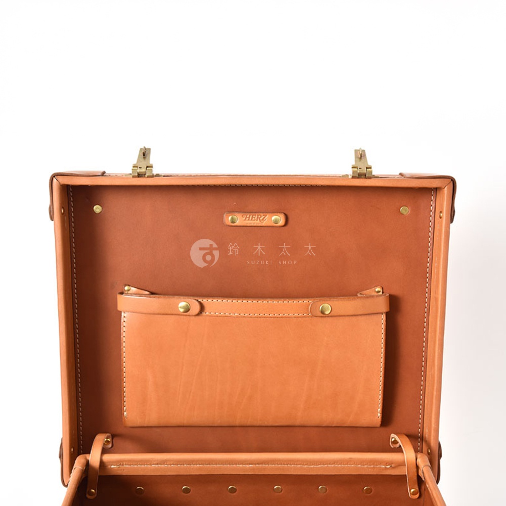 職人手作皮革英倫風便攜手提行李箱 TR-1，展示打開的狀態，內裡為淺棕色皮革，設有一個較大的皮製收納袋，配有黃銅色金屬扣件，箱體外觀為深棕色皮革。