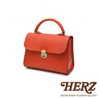 日本HERZ職人手作皮革多功能收納單肩包 Q-9，採用橘紅色Latigo軟皮革製作，搭配金色鎖扣和提把，呈現復古經典風格，側面有拉鍊設計，整體簡約實用。