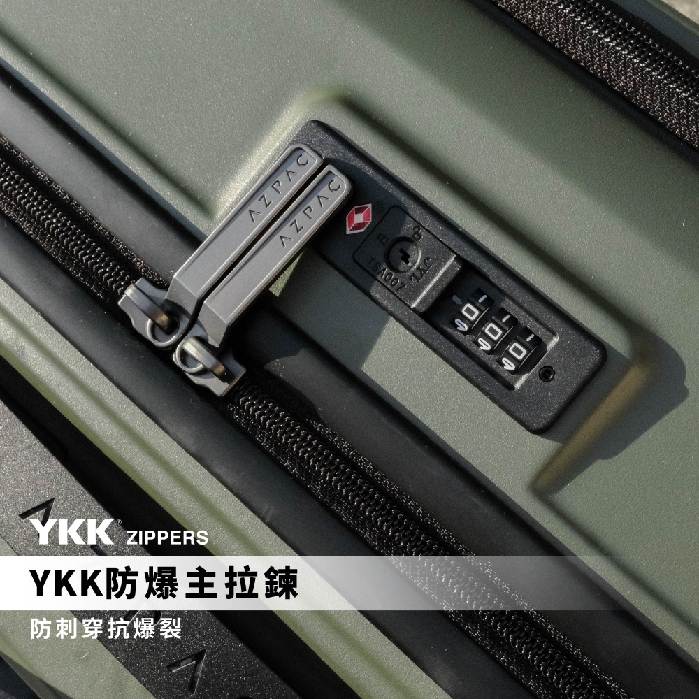軍綠色AZPAC行李箱的近拍視角，展示了配備YKK防爆拉鍊的黑色密封拉鍊邊條，上方嵌有印有AZPAC品牌名的金屬拉鍊頭，以及具備TSA007認證的黑色內嵌式三位數密碼鎖，呈現防刺穿與抗爆裂的結構細節。