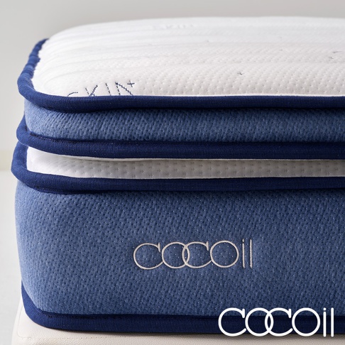 藍色與白色相間的雙層獨立筒美容床墊，側面織紋布料，頂部有白色滾邊與縫線，中間層和底部層為藍色布面，印有白色「COCOOIL」品牌標誌。