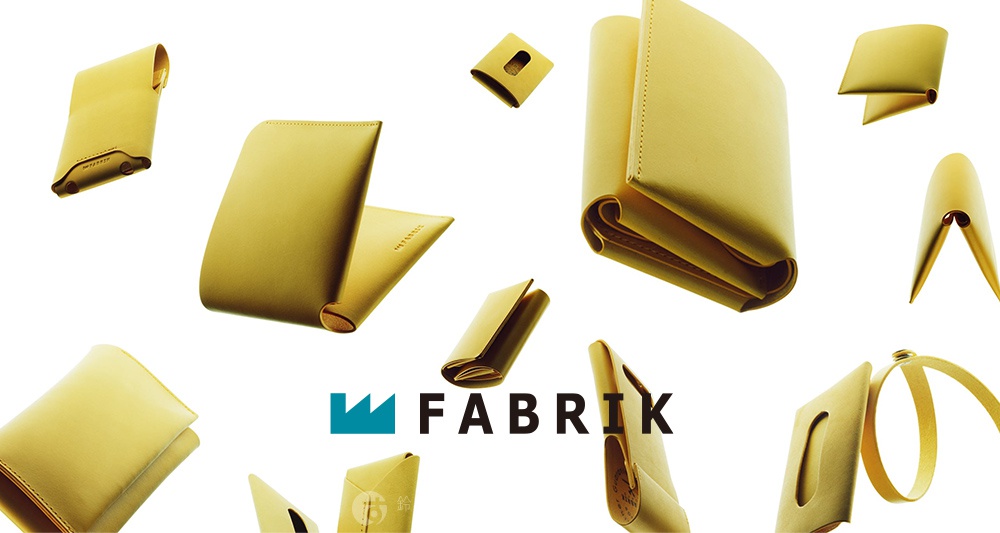 FABRIK 品牌標誌旁展示著多個黃色皮革製成的圓型收納鑰匙圈，以不同角度散佈於白色背景上。
