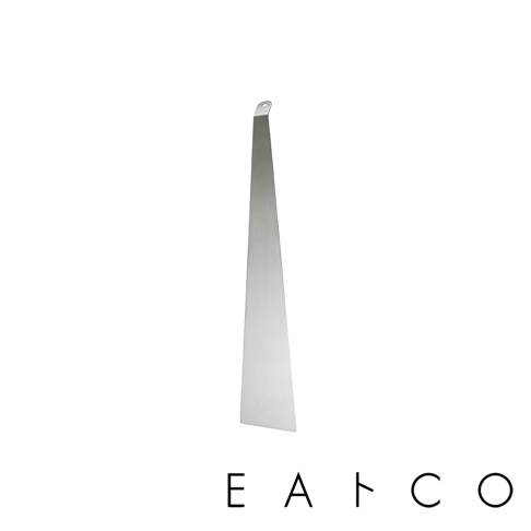 日製食物鏟，採用銀色不鏽鋼材質，整體呈細長梯形，末端有掛孔設計。