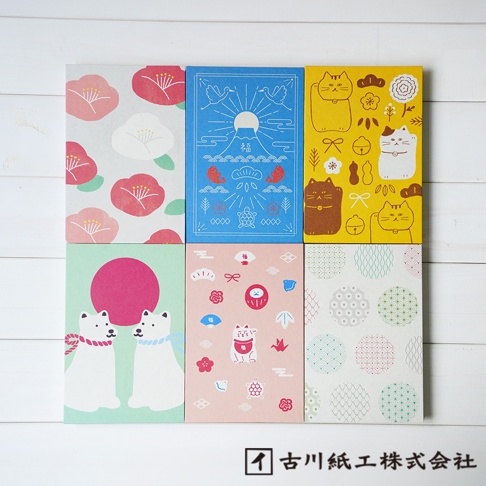 六款日式風格御朱印帳，封面分別為：粉紅色山茶花圖案、藍色富士山與吉祥物圖案、黃色招財貓與花朵圖案、薄荷綠背景的兩隻白犬與粉紅圓圈圖案、粉紅色達摩、招財貓與各種小物圖案、以及白色背景的綠色、粉紅色、藍色圓形幾何圖案。