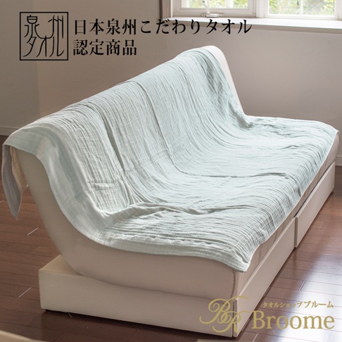 泉州SASARA四層紗毛巾毯，淺藍綠色，輕盈透氣，鋪蓋在白色沙發床上，展現其細緻的織紋。