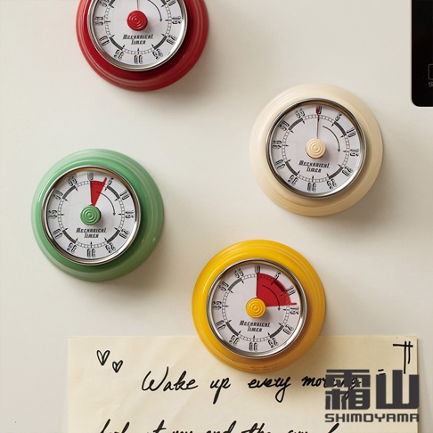 四個美式復古造型磁吸機械式計時器，分別為紅色、綠色、米白色和黃色。每個計時器皆為圓形，設有白色錶盤，上面有黑色刻度和數字，中央有圓形旋鈕和指針。
