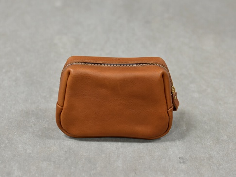 一個棕褐色的皮革拉鍊收納包，具有圓潤的邊角和金屬拉鍊。