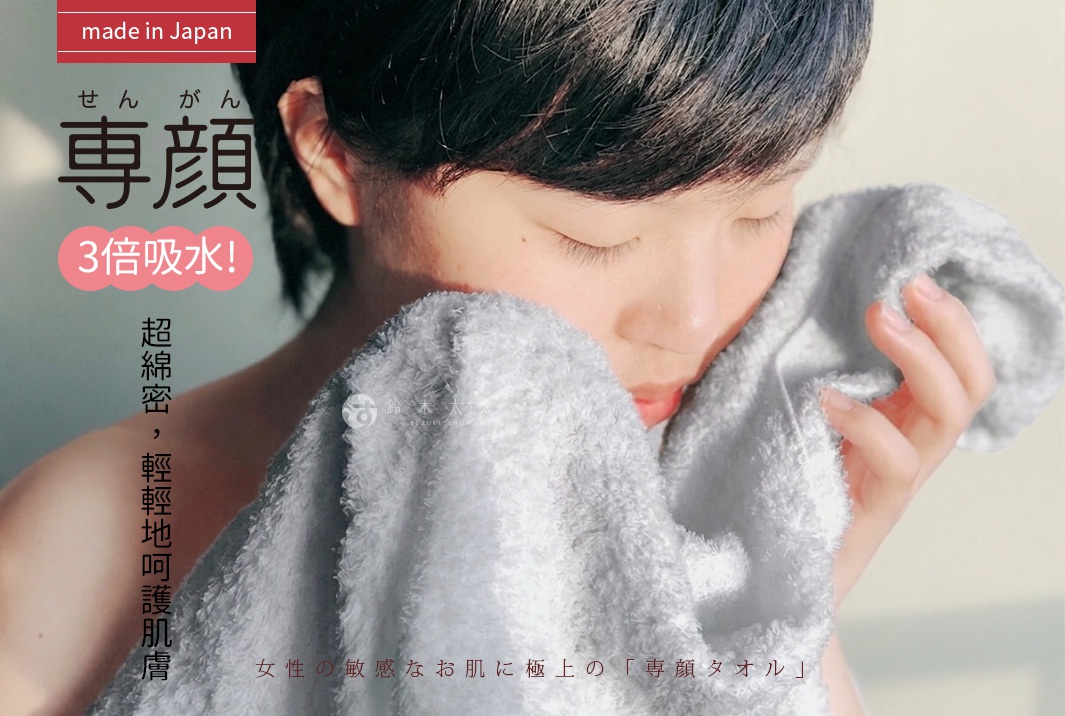 一位留著短髮的女性閉著雙眼，雙手輕柔地將一條灰色的純棉毛巾貼在臉頰上，感受柔軟親膚的觸感。圖片標題為專顏，強調三倍吸水與日本製的極致品質，專為女性敏感肌膚設計的優質毛巾。