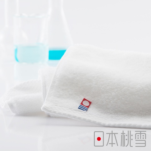一條白色今治超長棉方巾，質地柔軟，帶有品牌標誌。
