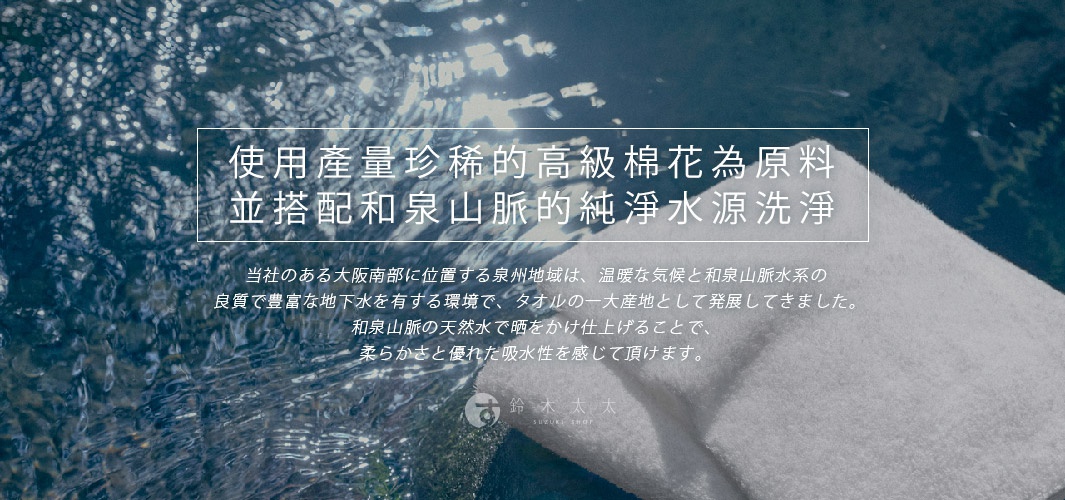 一條白色長纖迷你浴巾，材質柔軟，搭配藍色水波背景，浴巾部分有陰影，整體呈現乾淨且具質感的視覺。