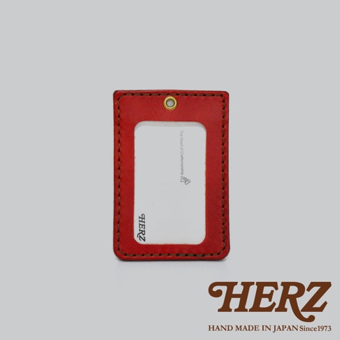 紅色皮革直式證件識別夾，邊緣有縫線，上方有金屬孔。夾內有白色卡片，印有品牌標誌與文字。