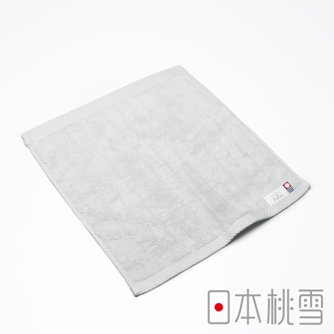 一條淺灰色今治超長棉方巾，表面柔軟，帶有細緻的菱格紋邊緣，右下角有品牌標籤，標籤上印有「huarte」字樣及日式圖案。