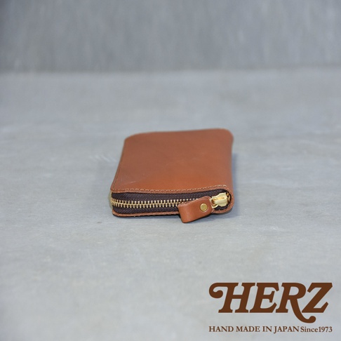 職人手作的咖啡色皮革Organ拉鍊長夾，採用黃銅色拉鍊和同色系皮革拉環，簡約設計，展現皮革質感。