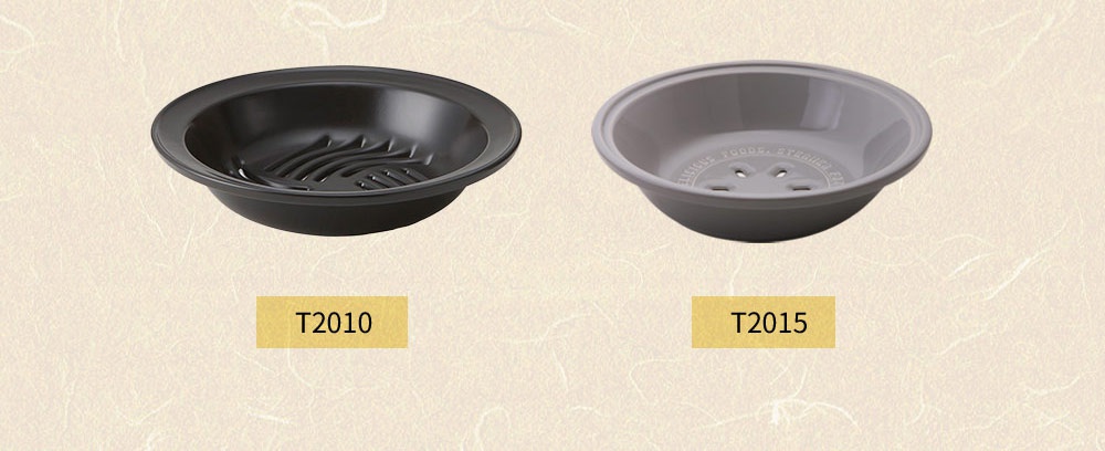 兩個 SUNOKO 耐溫差陶土蒸盤，左邊為深灰色，帶有條紋狀的底部設計；右邊為淺灰色，底部有圓形孔洞，並印有文字。