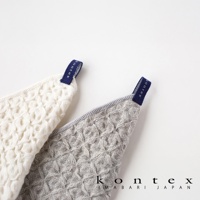 兩條棉麻混紡方巾，一條為白色，另一條為淺灰色，皆有鬆餅紋路，頂部有深藍色品牌標籤。