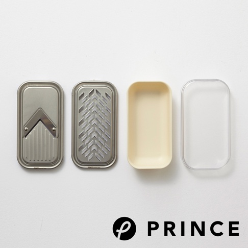 磨泥切片兩用盒，包含金屬切片器、金屬磨泥板、米白色收納盒及透明盒蓋，皆為長方形設計。