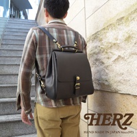 職人手作皮革屋瓦風後背包 R-15，黑色，以高品質皮革製成，設計簡潔，配有金屬扣環和提把，適合日常穿搭。