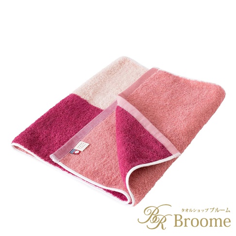 兩條今治KAKUTERU純棉毛巾，採用漸層混色設計，包含深粉紅、淺粉紅與米白色塊，觸感柔軟，邊緣帶有白色滾邊。
