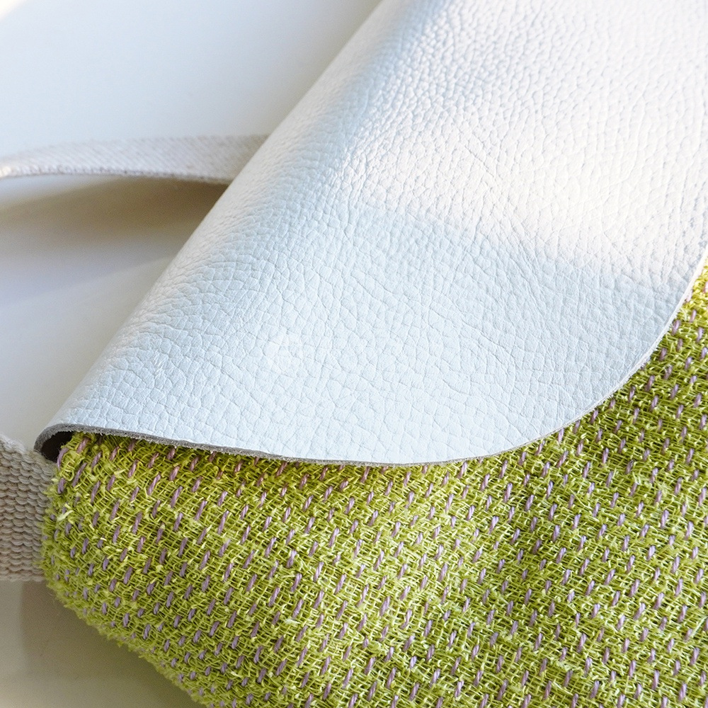 BAN INOUE 蚊帳棉裂織手提袋，以白色皮革翻蓋搭配淺綠色織布包身，呈現簡約自然的風格。