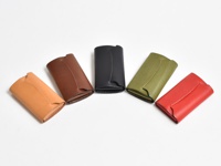 五個皮革迷你卡片收納夾，分別為卡其色、棕色、黑色、綠色和紅色，皆為簡潔的長方形設計，具有皮革材質的自然紋理。