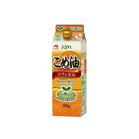 米糠玄米油 700g 紙盒包裝，頂部有旋轉蓋，盒身以黃色、白色和綠色為主，印有日文產品名稱「こめ油」及「コクと甘み」，另有炒物、炸物、沙拉醬等用途標示，下方有綠葉圖案及「スマートグリーンパック」字樣。
