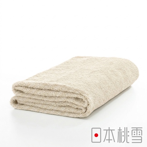 一張折疊整齊的米色精梳棉飯店浴巾，展示了厚實細緻的毛圈織法與柔軟質感，右下角印有日本桃雪品牌標誌與紅色圓點設計，背景為純白純淨風格。