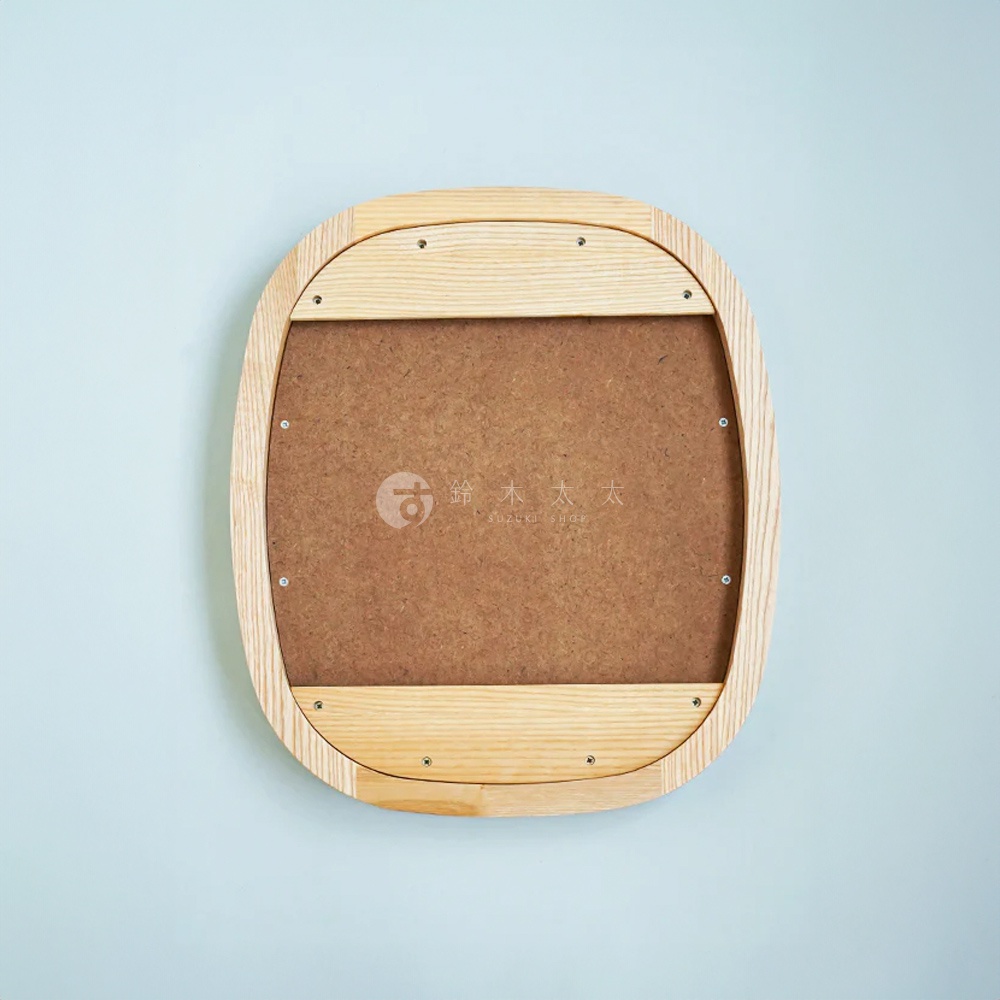 橢圓形鏡子，邊緣為淺木色木框，背面為棕色木質背板，由多塊木板拼接而成，並用螺絲固定。