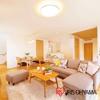 金屬邊框的圓形LED吸頂燈，散發柔和光線，照亮寬敞明亮的客廳空間，搭配木質家具與舒適的沙發。