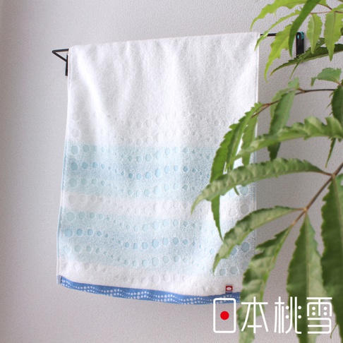 今治水泡泡毛巾，白色主體，織有藍色漸層水泡紋理，底部有藍色滾邊，材質為棉。