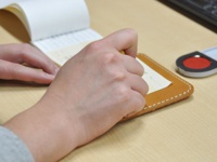 職人手作皮革印章墊板 (KZ-72)，淺棕色皮革，縫線清晰，搭配一本白色筆記本和紅色印台。