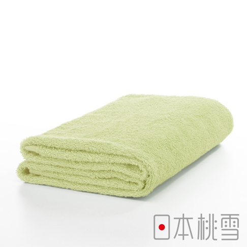 一條淺綠色的精梳棉飯店浴巾，質地柔軟，對折疊起，呈現蓬鬆的觸感。